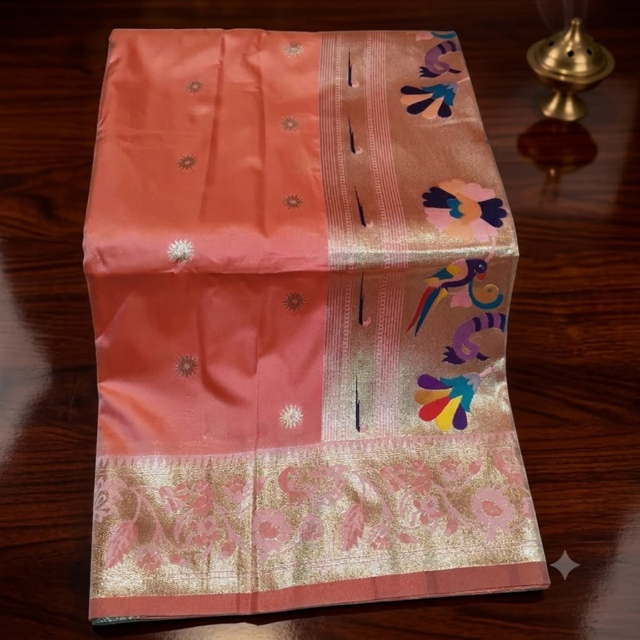 City Center peach pure silk Muniya Paithani saree featuring a gold zari border and vibrant handwoven parrot motifs