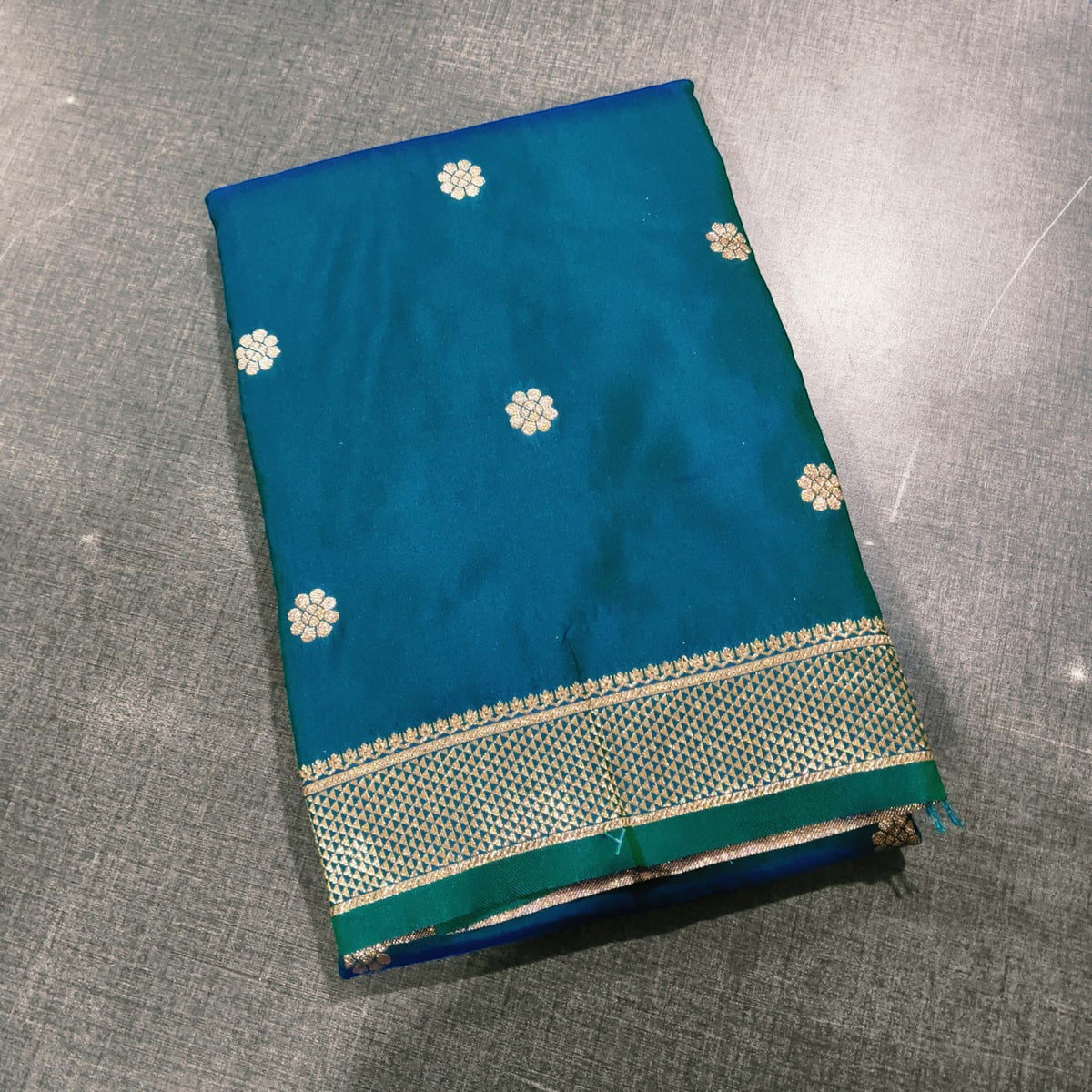 City Center Peshwai saree in teal silk with gold zari floral motifs and a traditional ornate border.