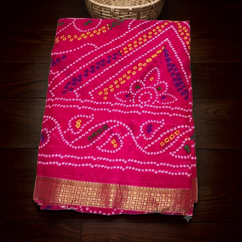 City Center Bandhan silk saree in vibrant pink with traditional bandhani tie-dye patterns and a gold woven border.