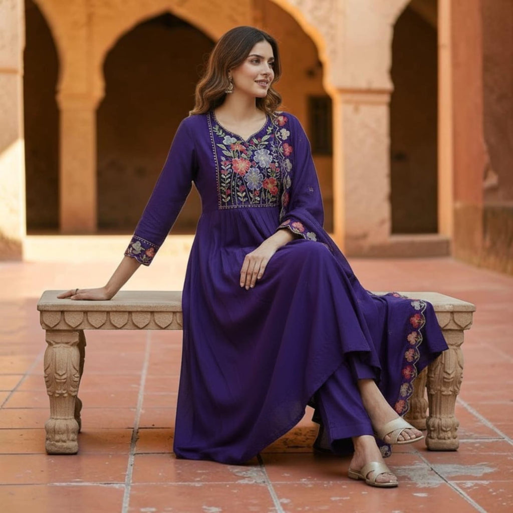 City Center deep purple denim kurti featuring floral embroidery on the yoke and sleeves, worn by a seated woman.