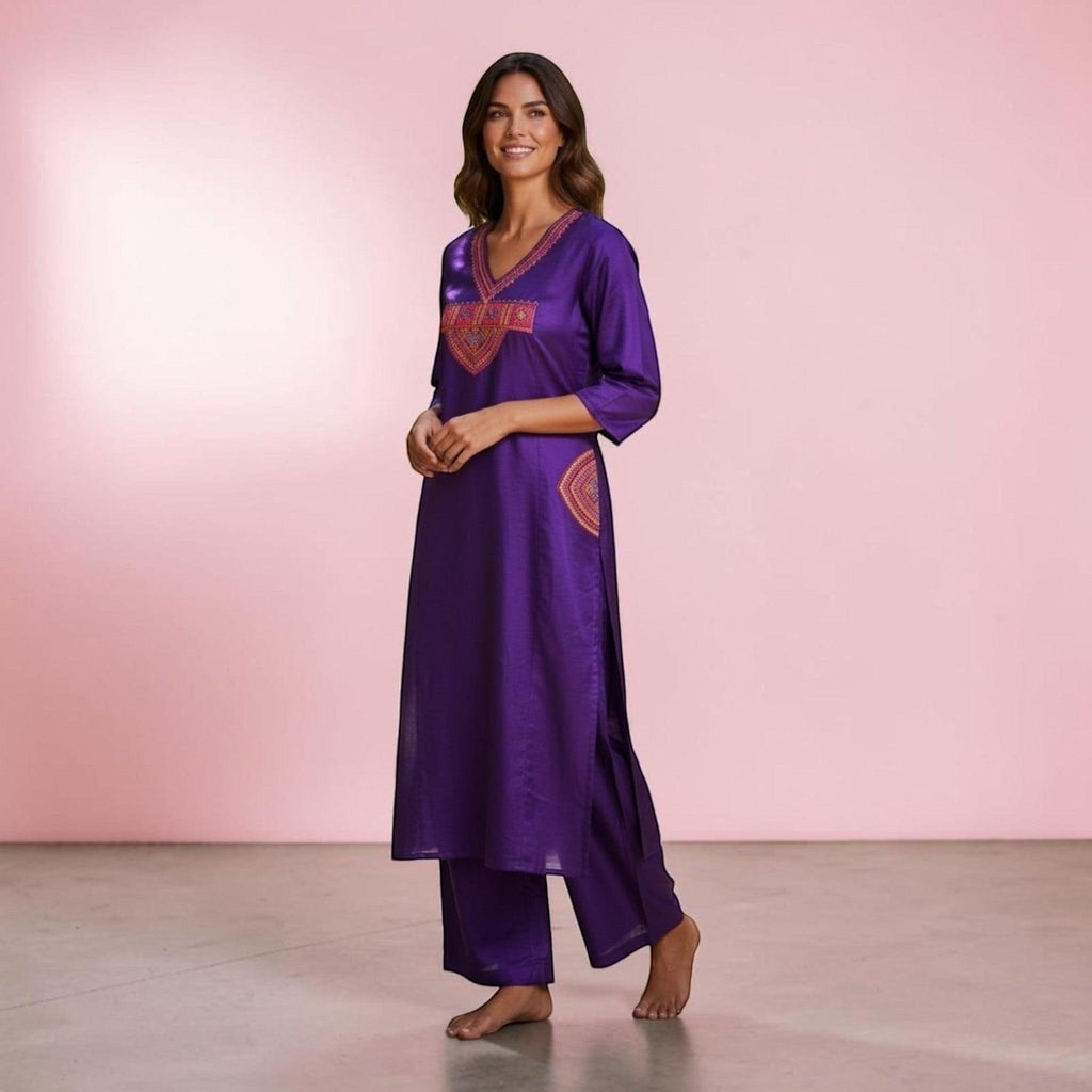 City Center purple ethnic kurta and pant set with vibrant embroidered V-neckline and side pockets on a smiling model