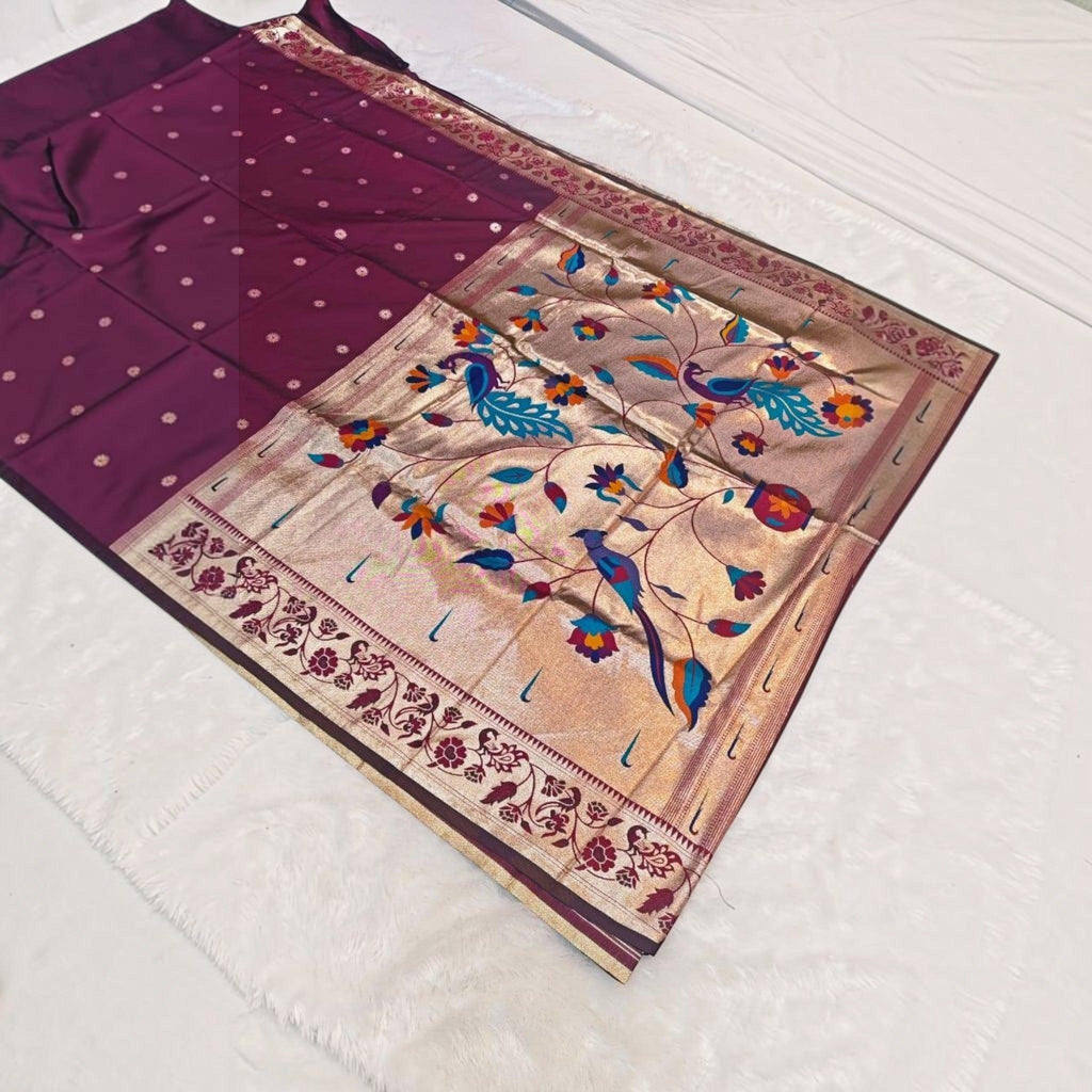 City Center traditional deep purple silk saree with a wide gold border featuring intricate peacock and floral motifs.
