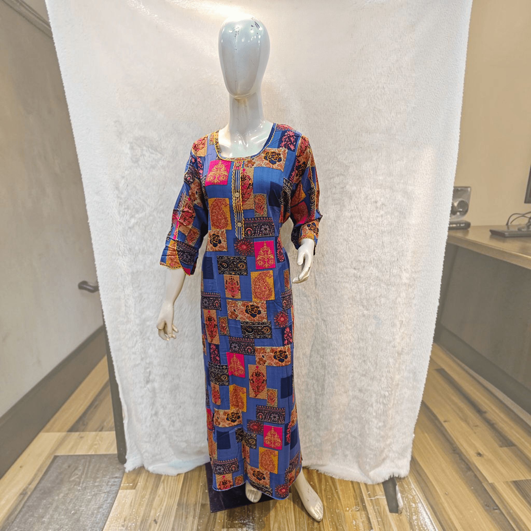 City Center heavy rayon A-line gown featuring a vibrant blue patchwork print with pink and orange floral patterns.