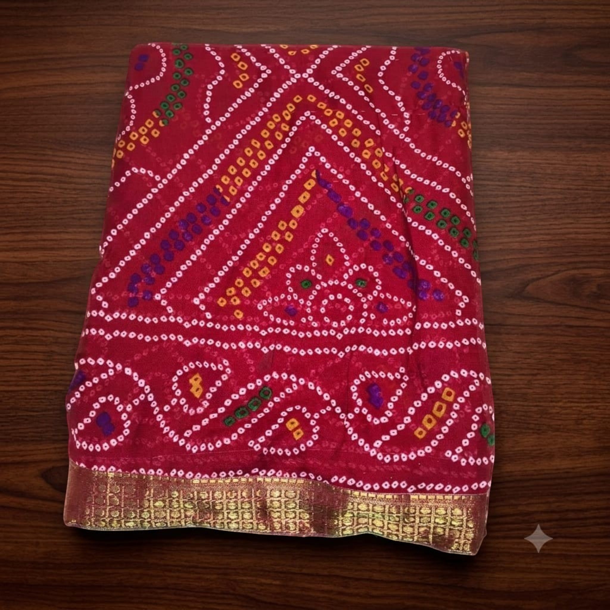 City Center Bandhan silk saree in deep red with traditional multi-colored bandhani patterns and a gold woven border.