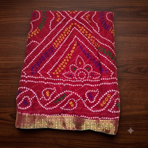 City Center Bandhan silk saree in deep red with traditional multi-colored bandhani patterns and a gold woven border.