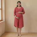 City Center maternity and nursing gown in red cotton with a geometric print, featuring concealed feeding zippers.