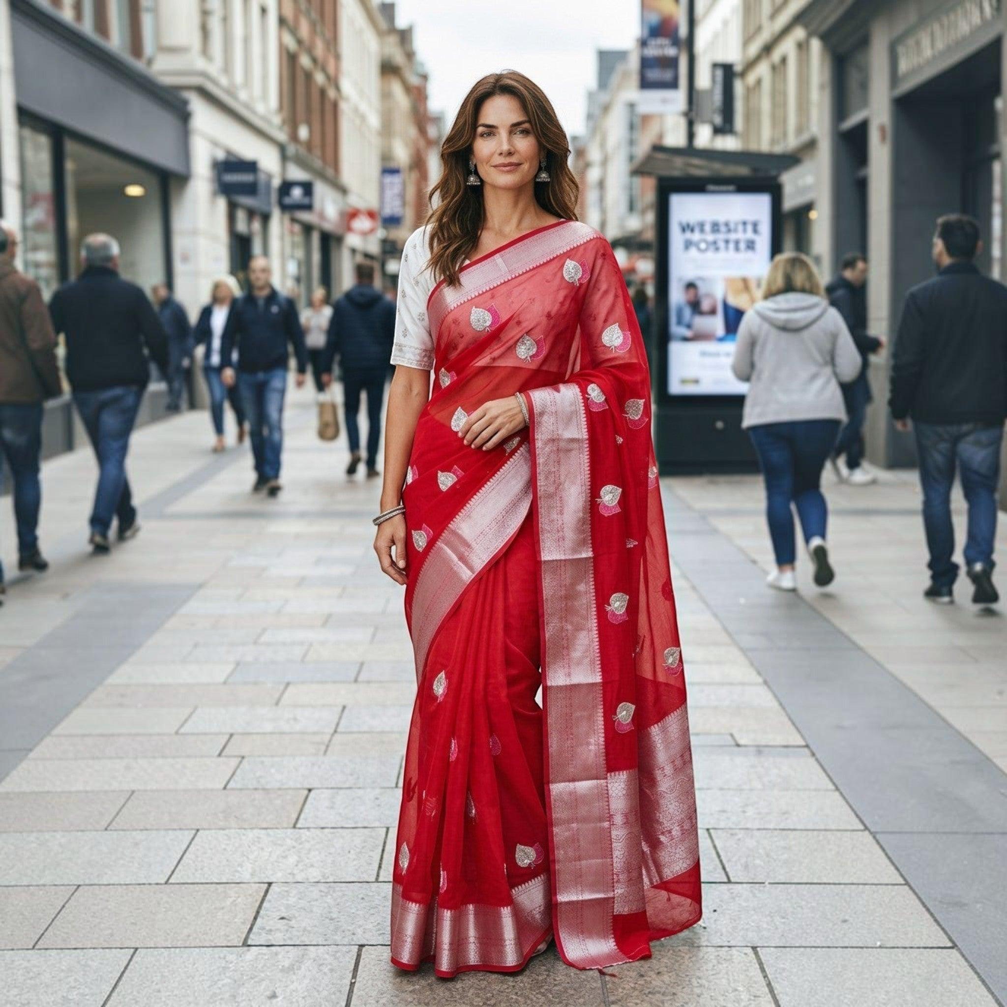 City Center red organza saree with silver floral motifs and a white blouse worn by a woman on a city street