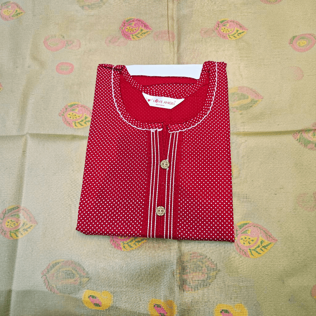 City Center red rayon A-line gown with white polka dots, round neckline, and decorative buttons on a patterned base.