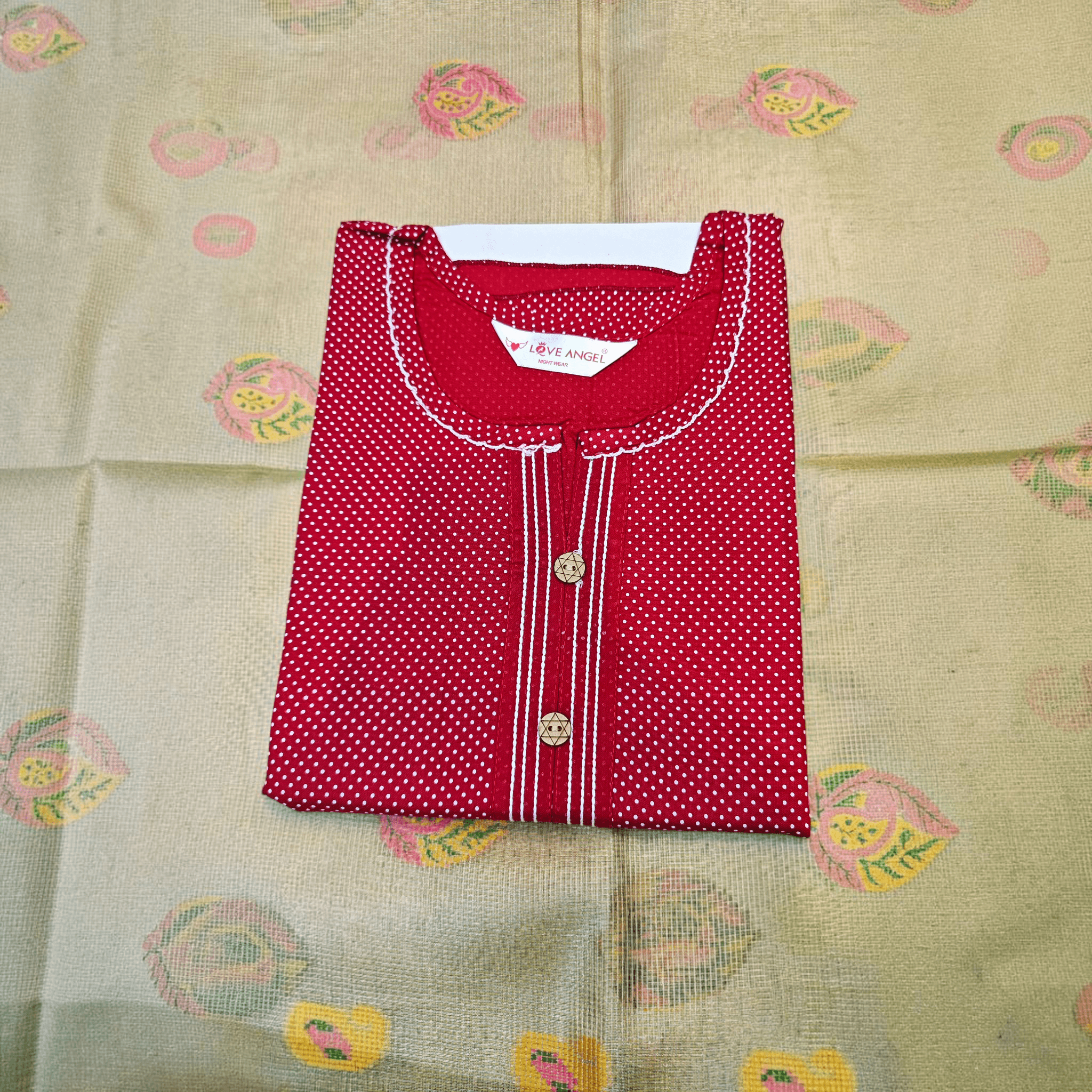 City Center red rayon A-line gown with white polka dots, round neckline, and decorative buttons on a patterned base.