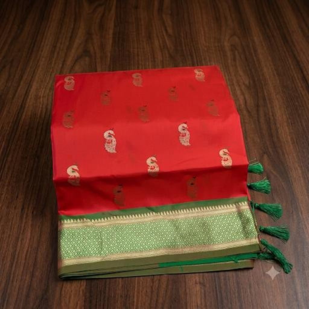 City Center red pure silk Paithani saree with gold zari peacock motifs and a green border on a wooden background