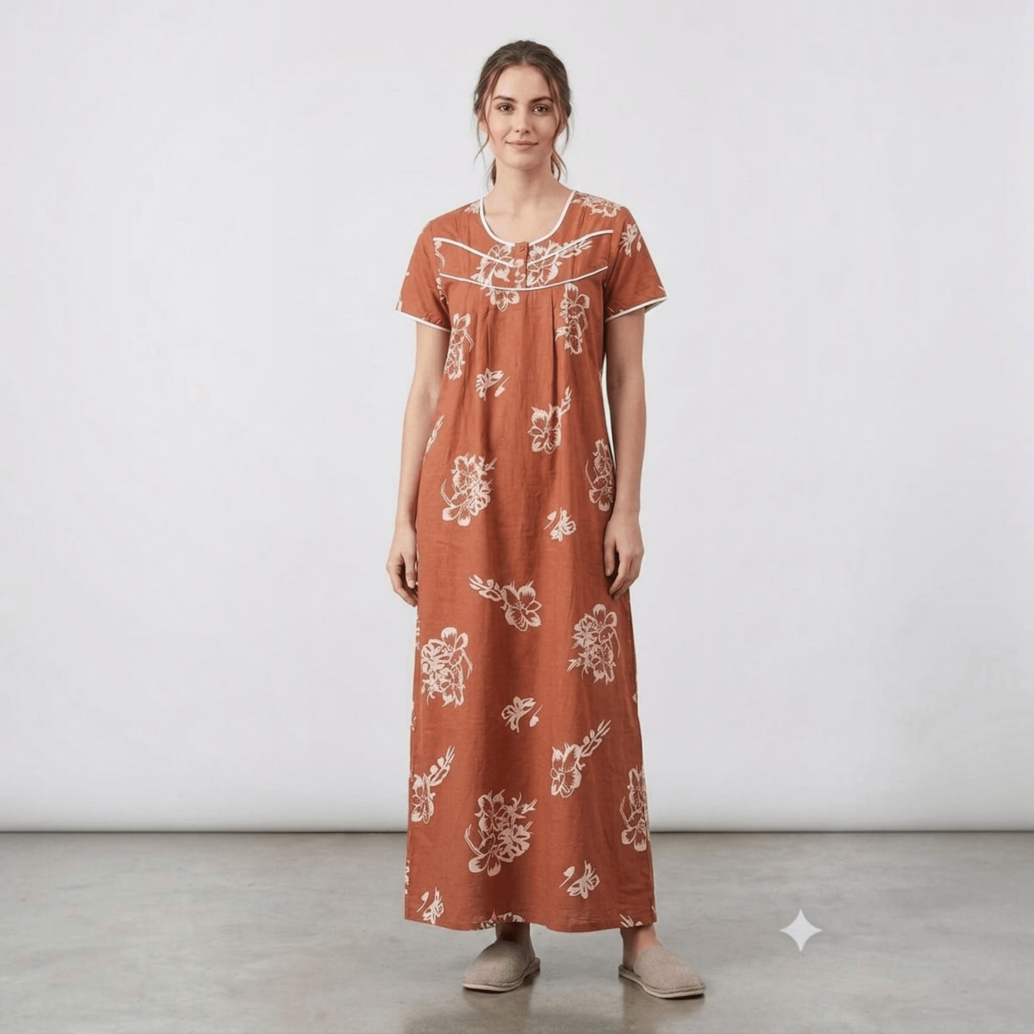 City Center women's rust-coloured floral feeding gown in soft alpine fabric with front pleats and white embroidery.