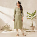 City Center sage green straight kurti with delicate white embroidery, worn by a woman with cream trousers.