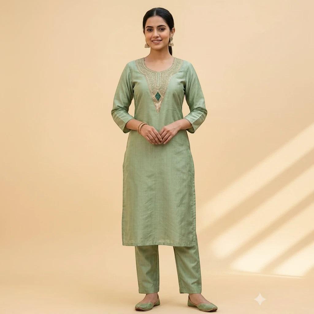 City Center sage green co-ord set with embroidered neckline and vertical textured fabric worn by a woman.