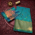 City Center teal satin saree with gold kattpadar border and peacock Aari embroidery on the matching blouse piece