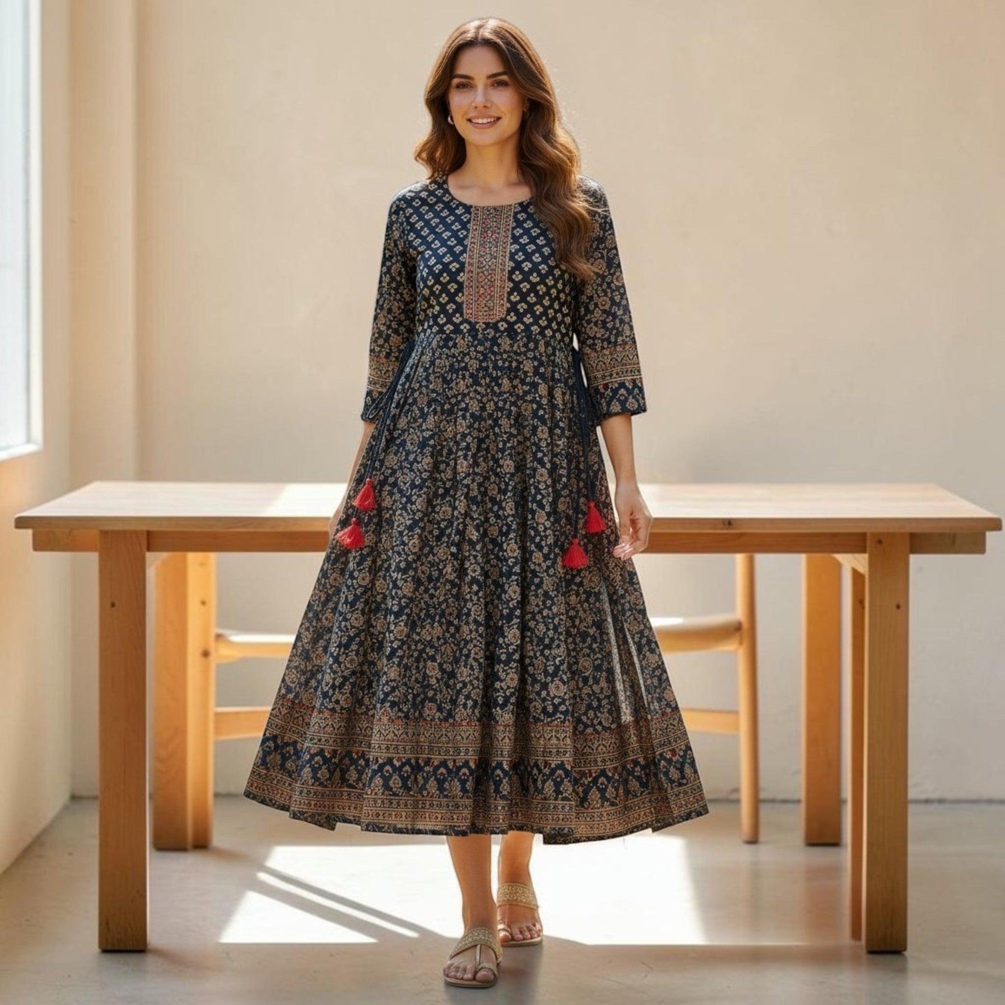 City Center Simra Anarkali Kurti in navy blue with intricate ethnic gold print, flared silhouette, and red tassels.