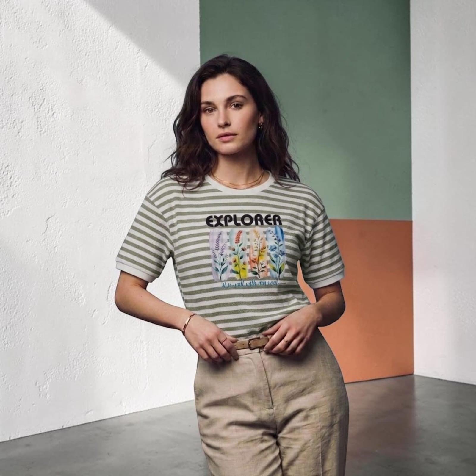 City Center premium cotton t-shirt with green stripes and floral Explorer graphic print worn by a woman.