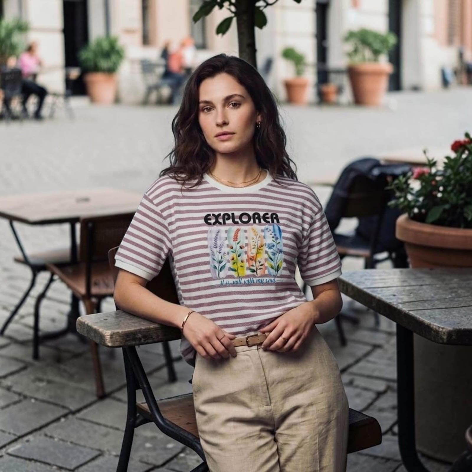 City Center premium cotton t-shirt with striped pattern and floral Explorer graphic print worn by a woman outdoors.