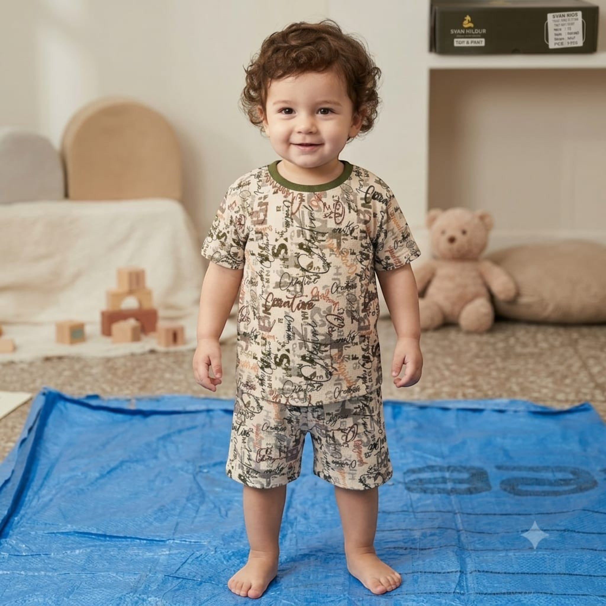 City Center Svan Hildur boys co-ord set featuring a beige short-sleeve top and shorts with a graphic print