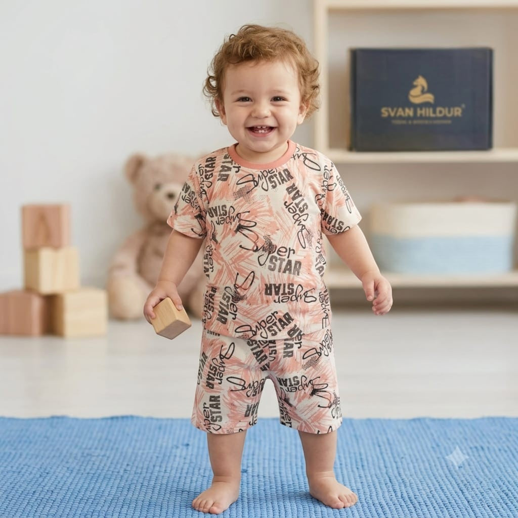 City Center Svan Hildur toddler boy wearing a peach co-ord set with black palm leaf and superstar print