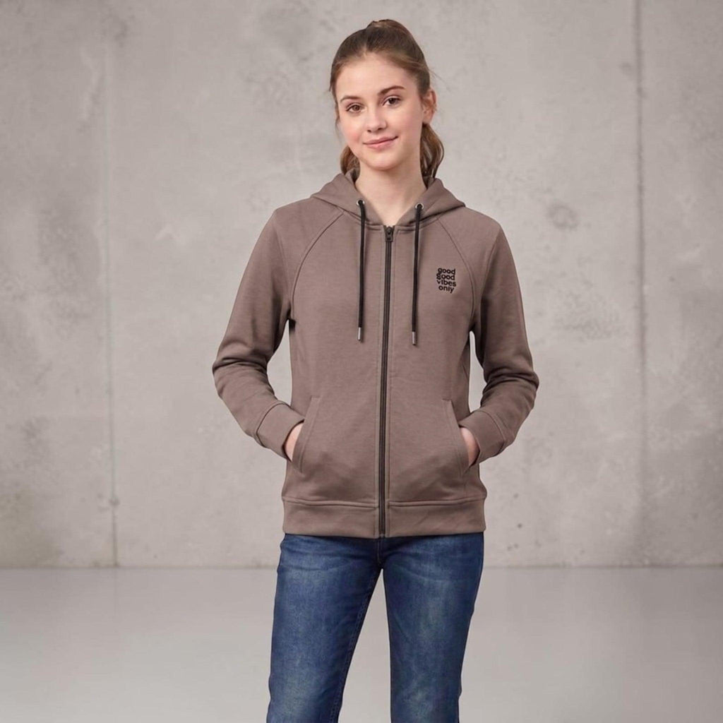 City Center taupe full-zip hooded sweatshirt with raglan sleeves and good vibes only chest graphic on a young woman