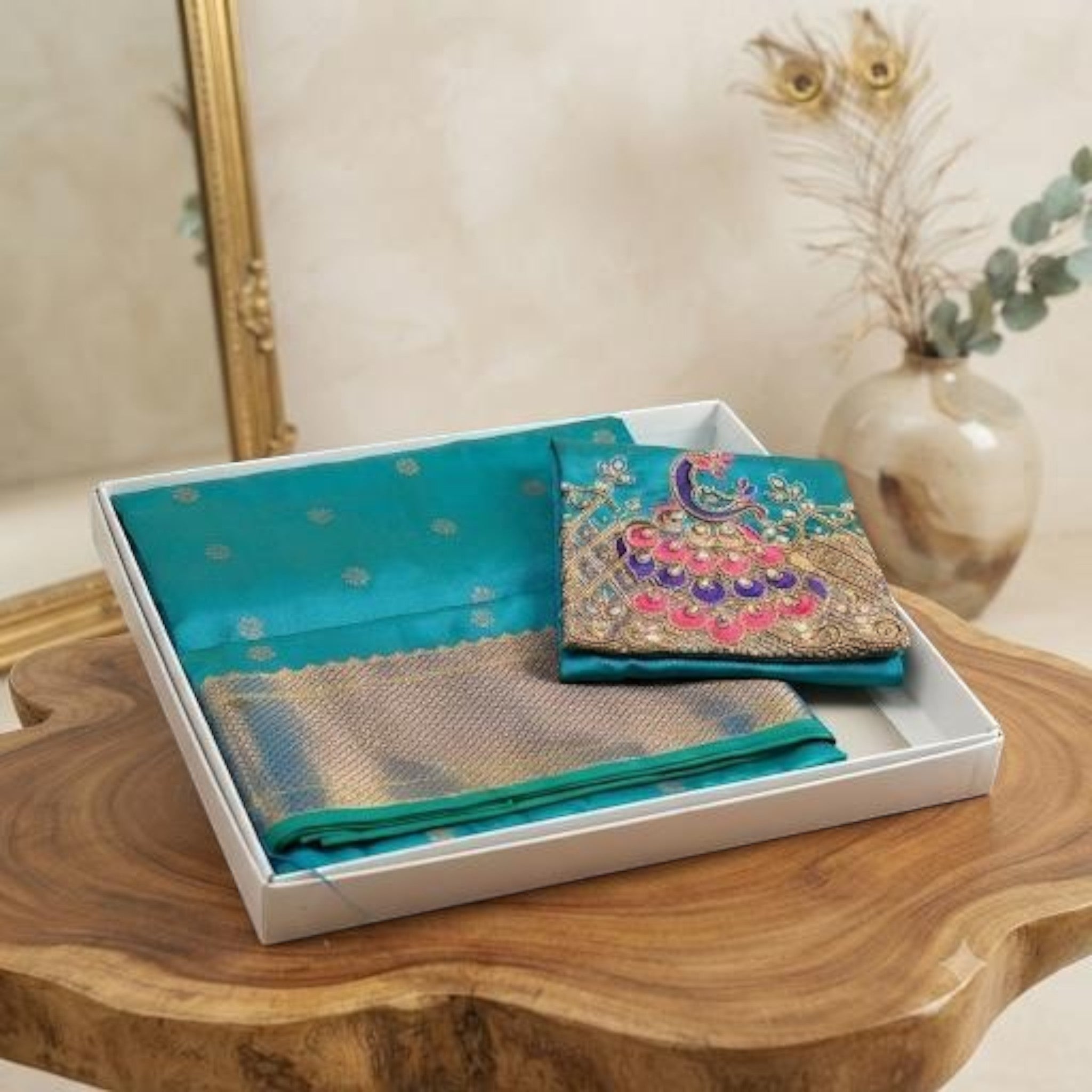 City Center Kalanjali Aari work saree in teal with intricate peacock embroidery and gold zari border in a gift box