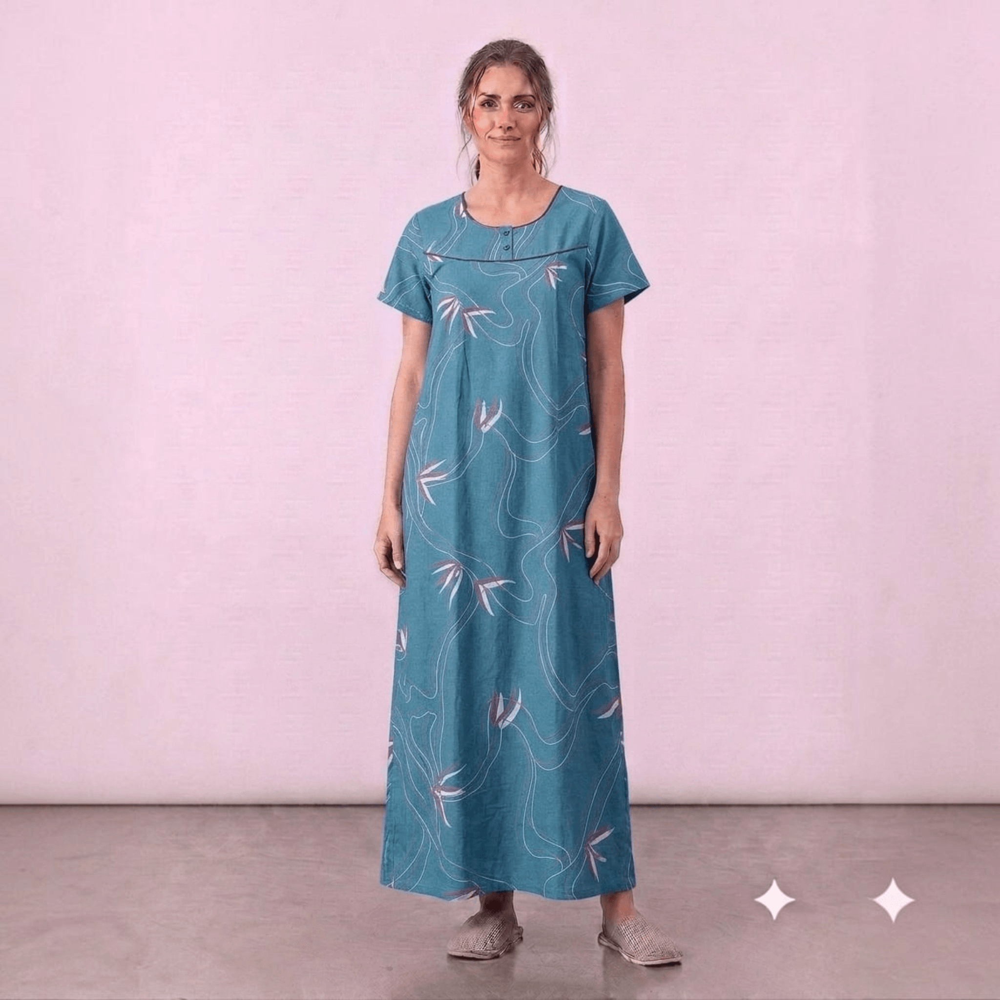 City Center teal cotton feeding gown with white floral line art, short sleeves, and elegant neck embroidery.