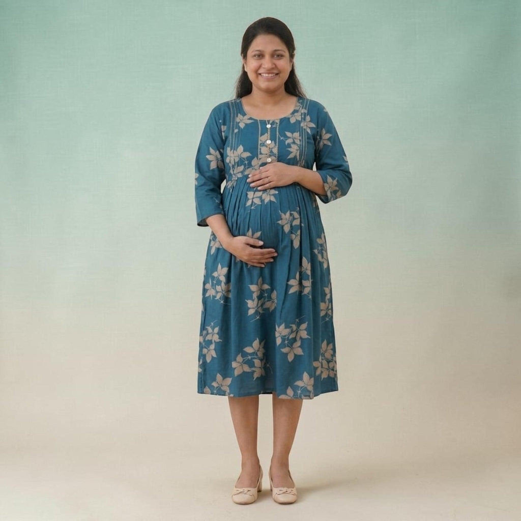 City Center maternity and nursing gown in teal cotton with beige leaf print, featuring concealed zippers for feeding.