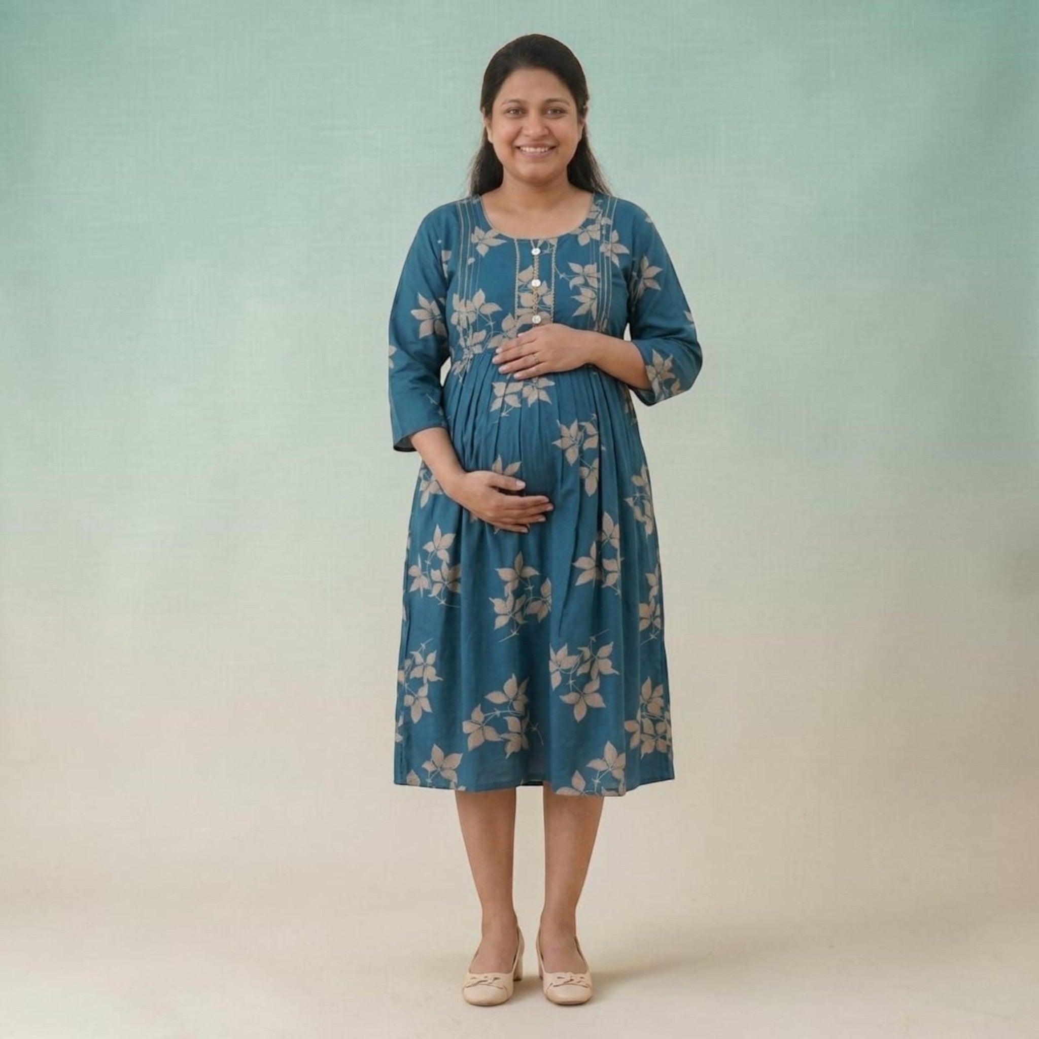 City Center maternity and nursing gown in teal cotton with beige leaf print, featuring concealed zippers for feeding.