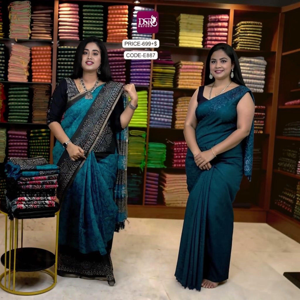 Two women wearing elegant teal cotton sarees with intricate black borders from the City Center collection.