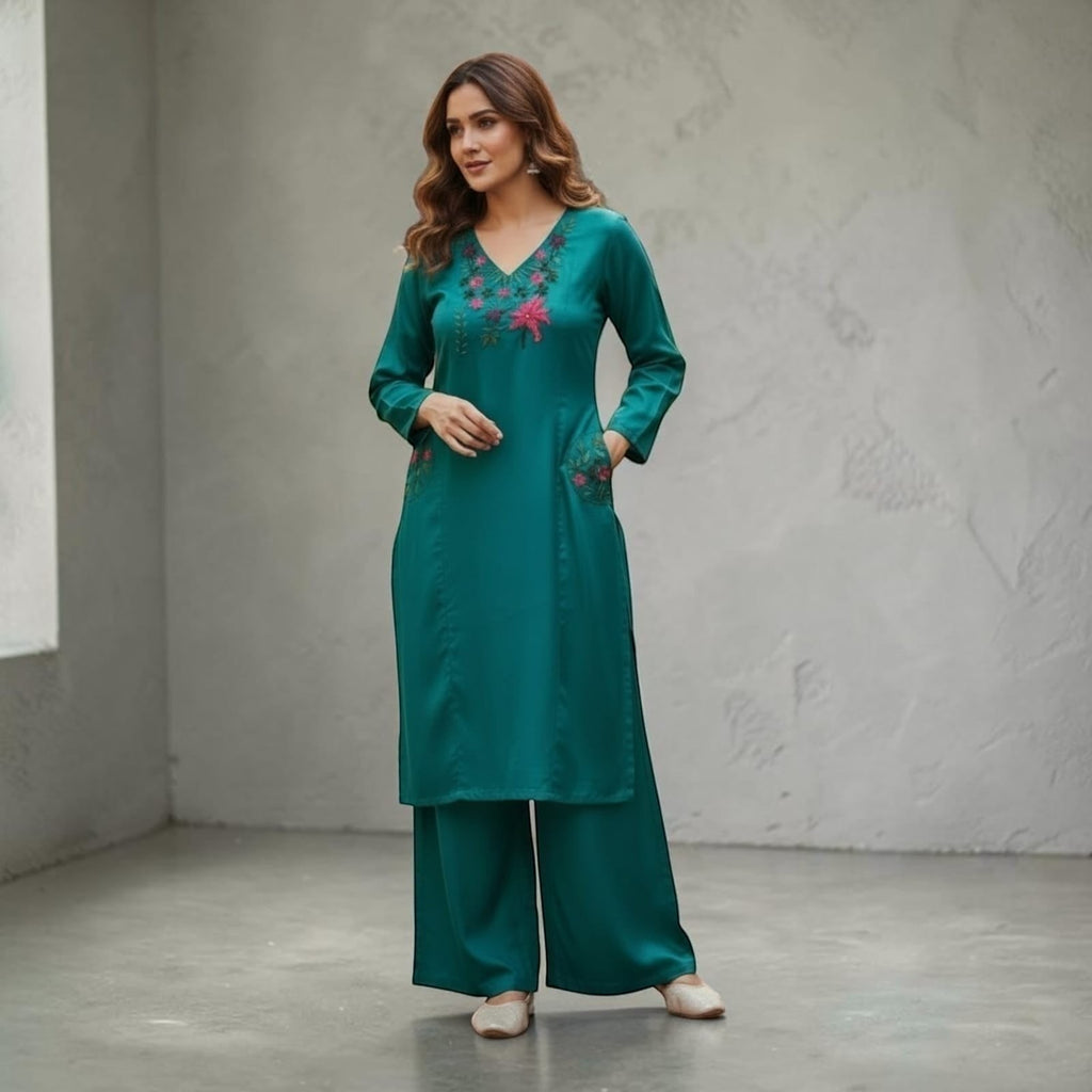 City Center teal kurta and palazzo set with floral embroidery on the neckline and pockets, worn by a woman.