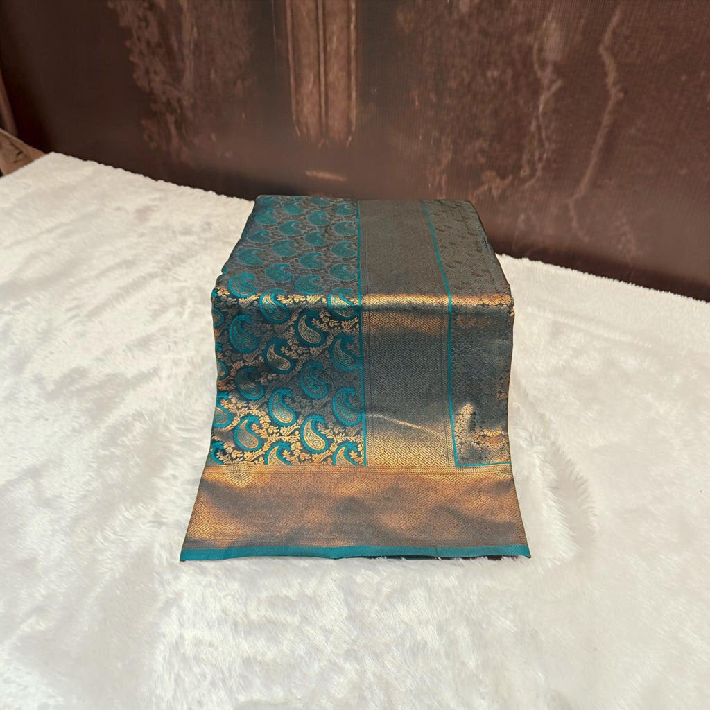 City Center teal and gold satin silk saree featuring intricate paisley patterns and a wide metallic border.