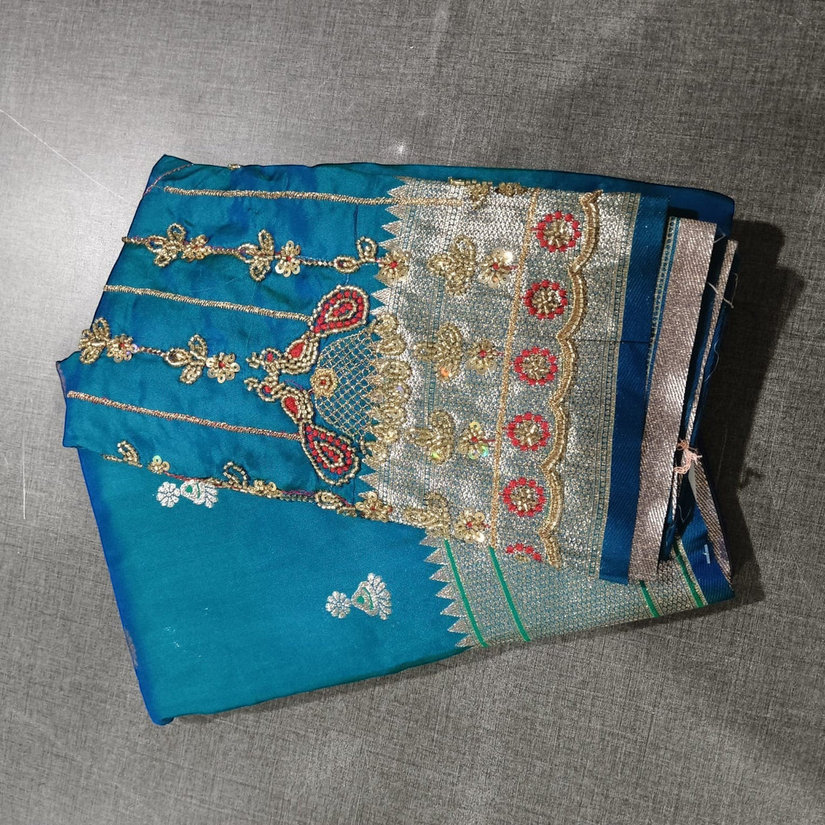 City Center teal Jhumka Paithani saree with intricate gold and red Aariwork embroidery on the blouse