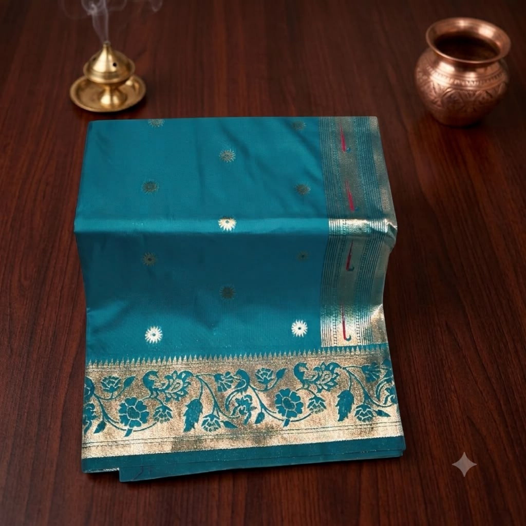 City Center Muniya Paithani pure silk saree in teal with gold zari parrot motifs and floral border on wooden table