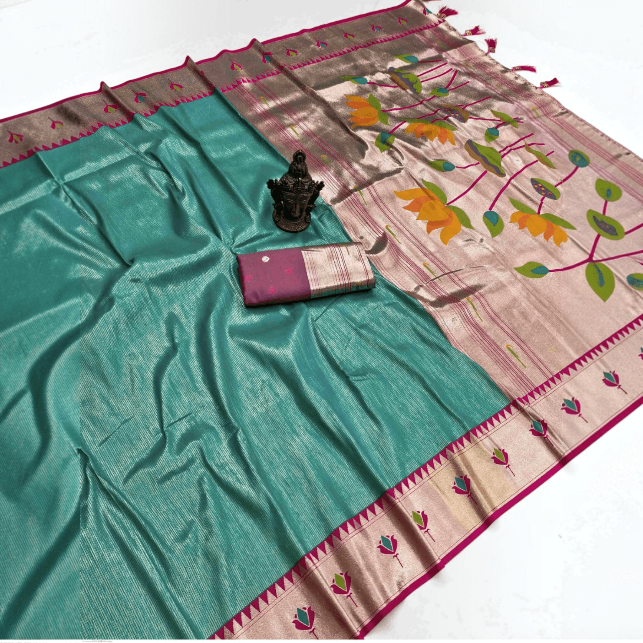 City Center teal tissue Paithani saree with metallic lotus motifs on the pallu and a matching premium blouse piece.