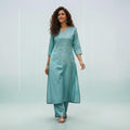 City Center teal Vatican fabric cord set featuring a kurti with delicate floral embroidery and matching trousers.