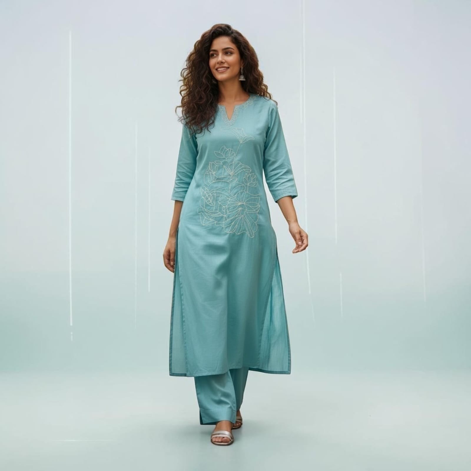 City Center teal Vatican fabric cord set featuring a kurti with delicate floral embroidery and matching trousers.