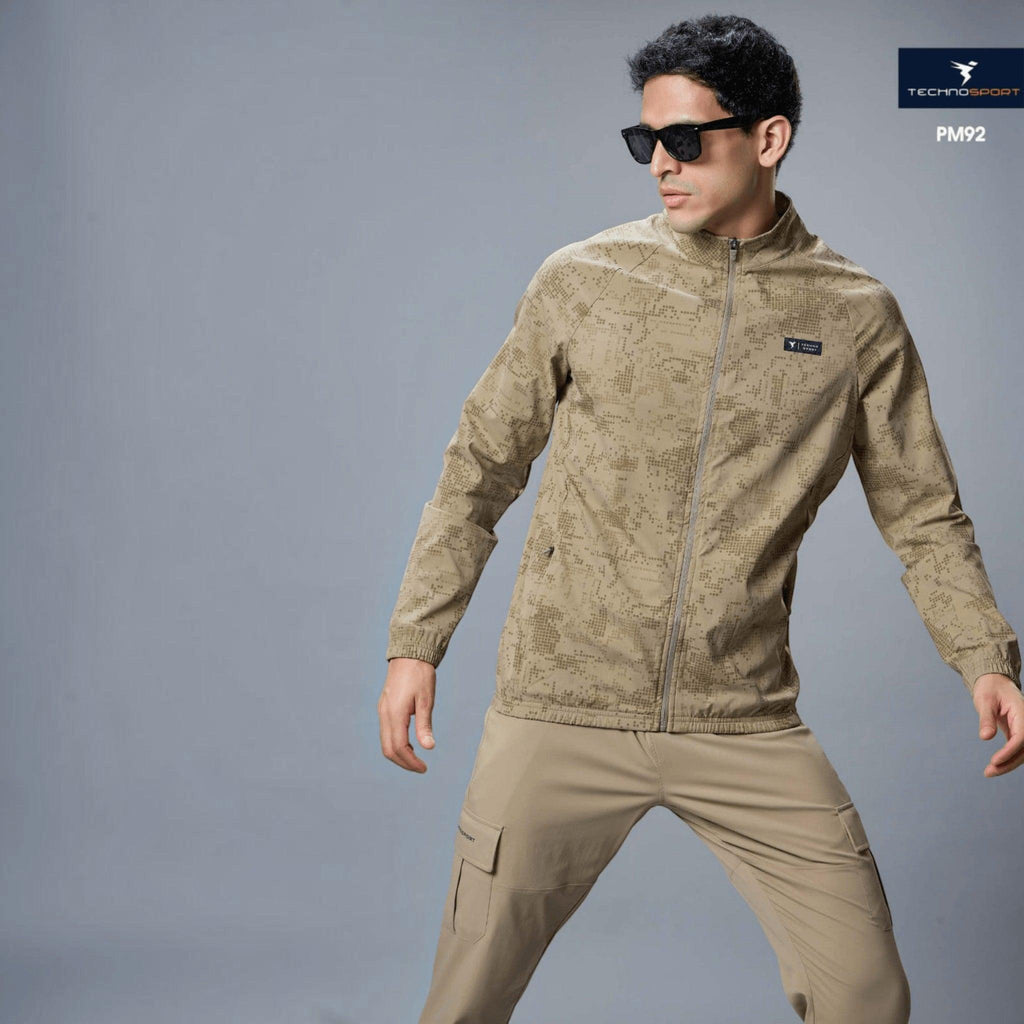 City Center Technosport men's beige hi-neck jacket with AOP pattern, featuring 2-way stretch and moisture-wicking fabric.