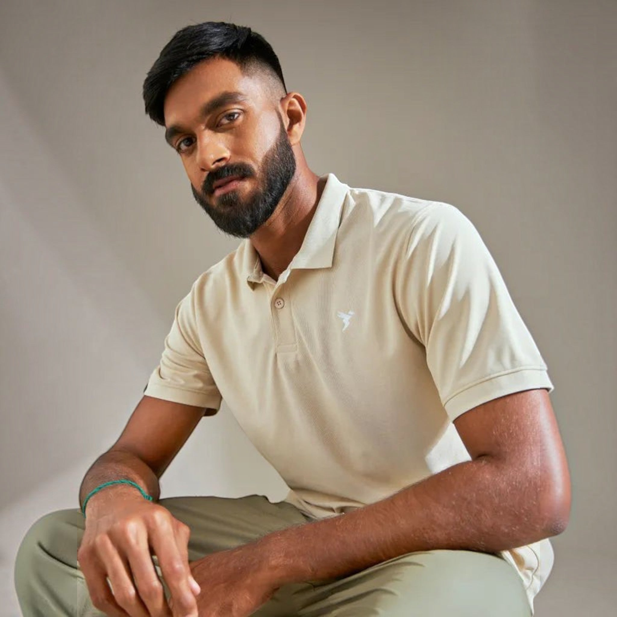 City Center TechnoSport OR-11 beige dry fit polo neck t-shirt worn by a man with a beard in a studio setting