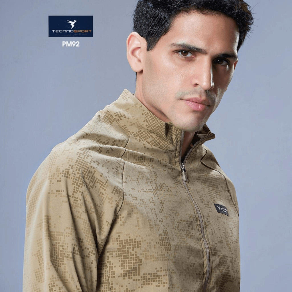 City Center model wearing a beige Technosport hi-neck jacket with a subtle geometric AOP print and front zipper
