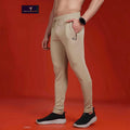 City Center Technosport slim fit beige track pants with moisture-wicking fabric and zippered pockets on a model