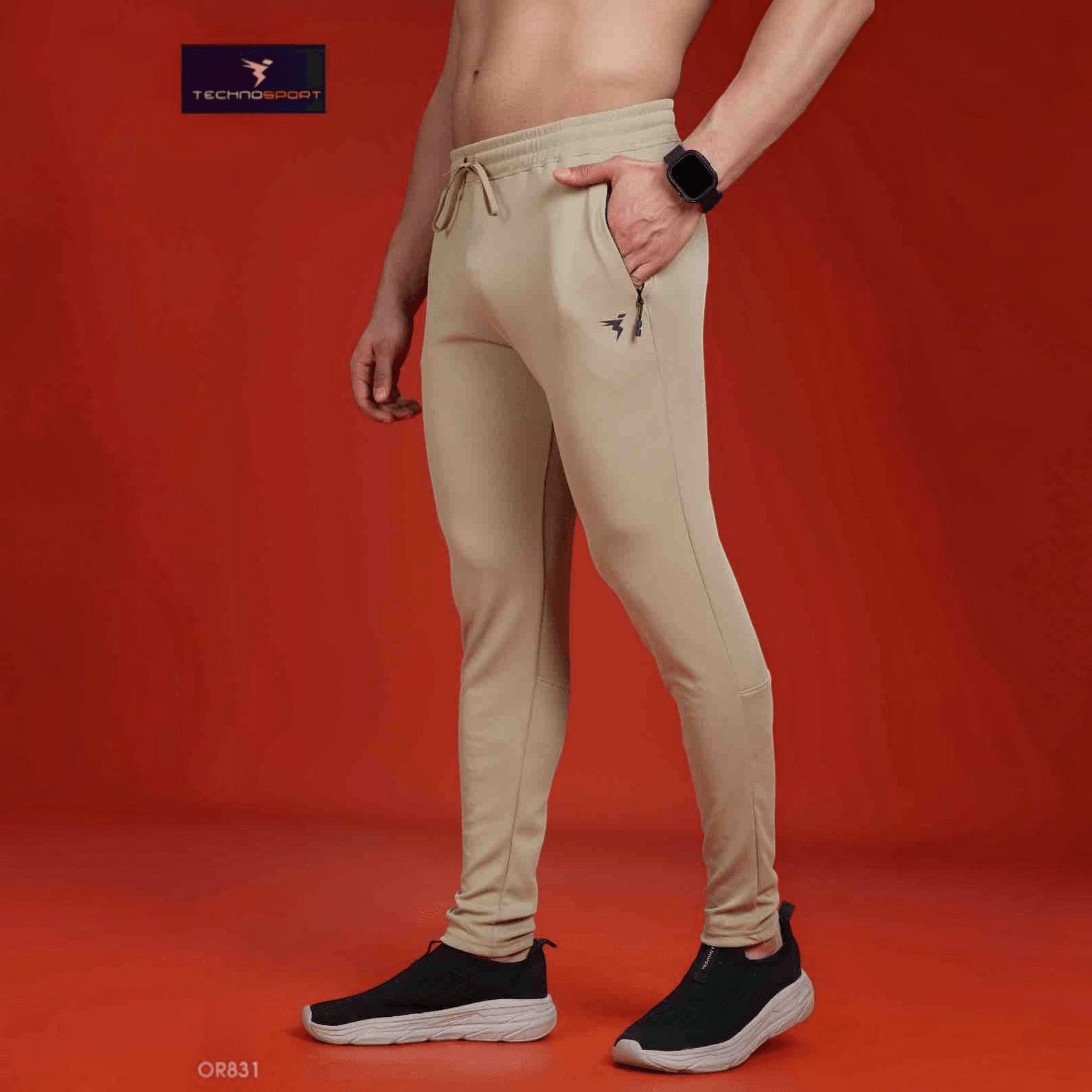 City Center Technosport slim fit beige track pants with moisture-wicking fabric and zippered pockets on a model