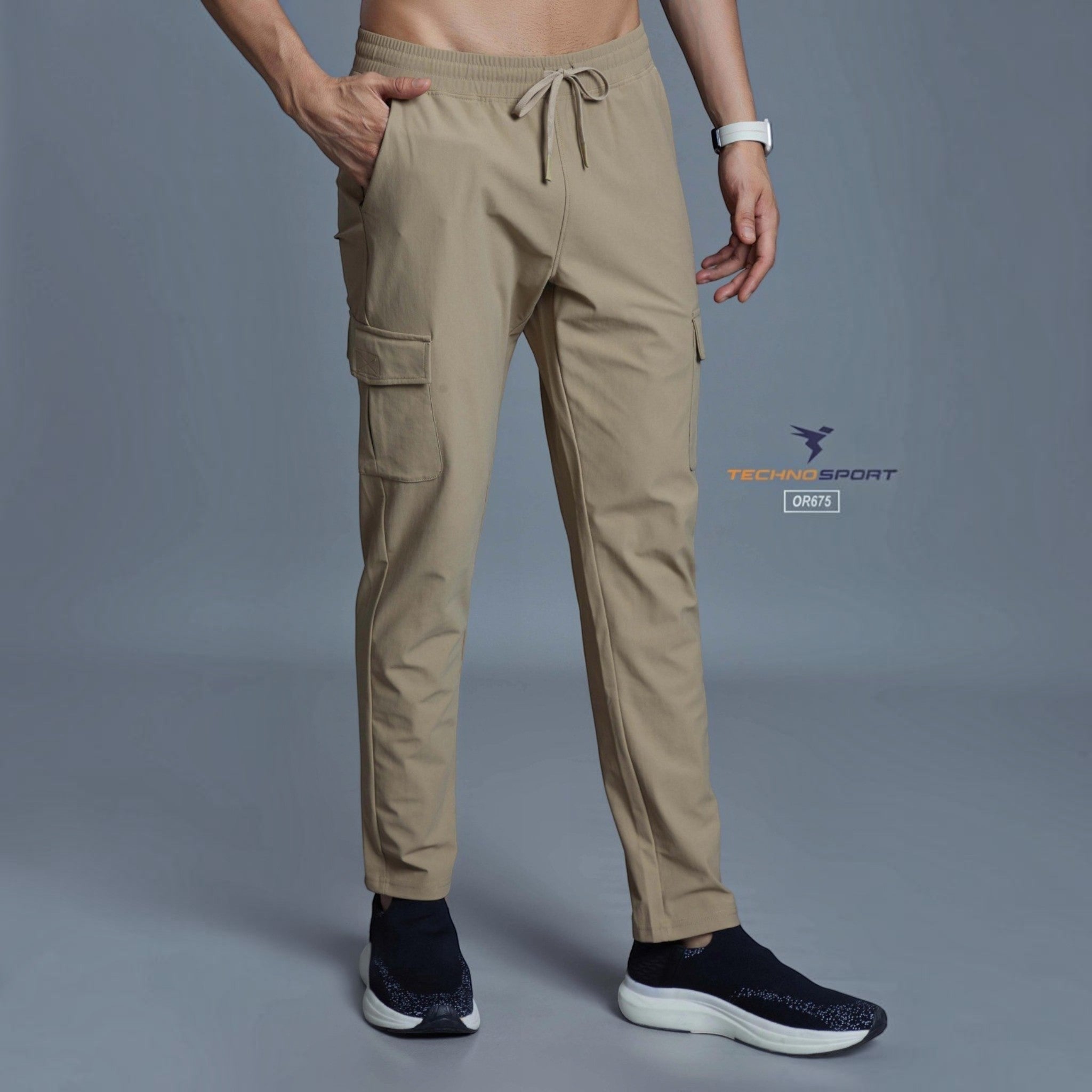 City Center Technosport OR675 beige tapered track pants with cargo pockets and drawstring waist on a male model