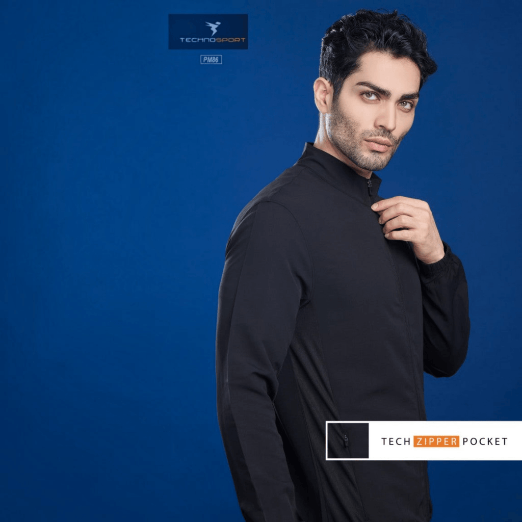City Center Technosport TS Flexi black performance jacket with high collar and tech zipper pocket on a blue background.