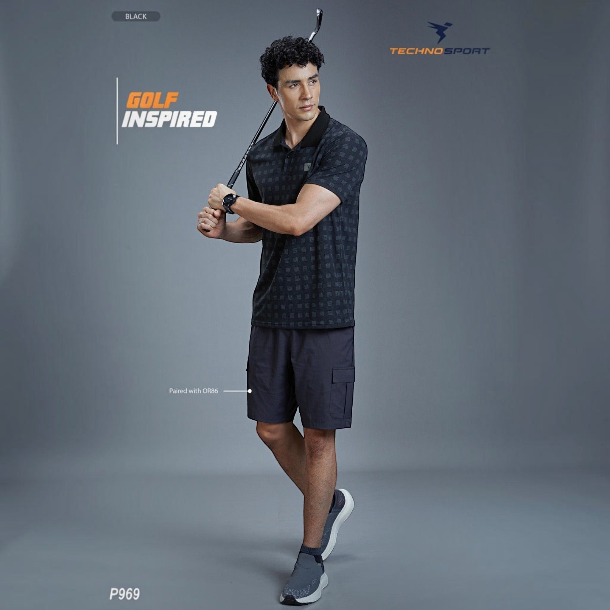 City Center model wearing a black patterned Technosport P969 moisture-wicking golf polo shirt with dark shorts.