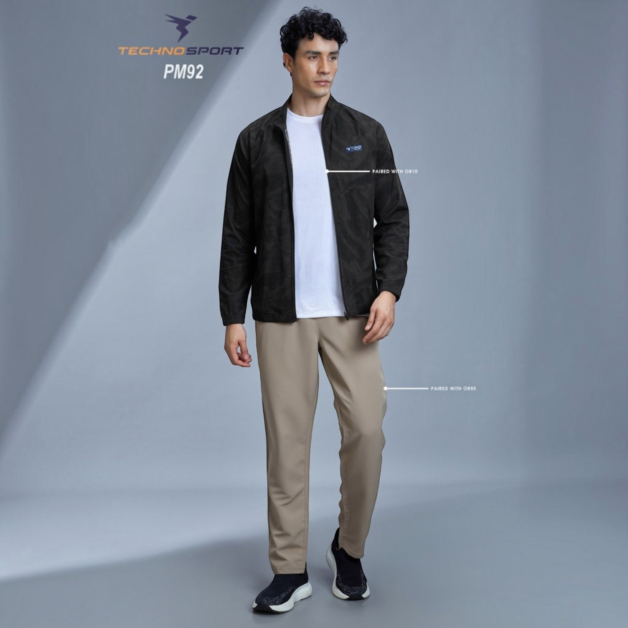 City Center Technosport full-sleeve black hi-neck jacket with subtle all-over print worn by a male model