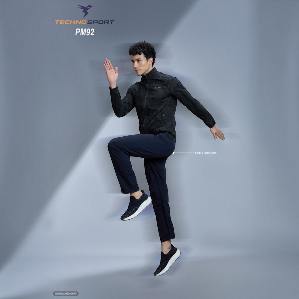 City Center model wearing a black Technosport solid hi-neck AOP jacket with full sleeves and odour-free technology.