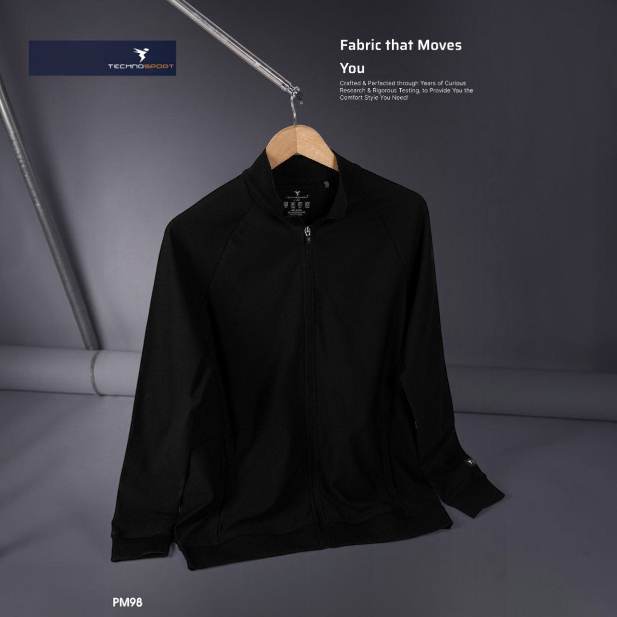 City Center Technosport DuraCool+ black high-neck jacket with full zip and moisture-wicking fabric on a hanger.