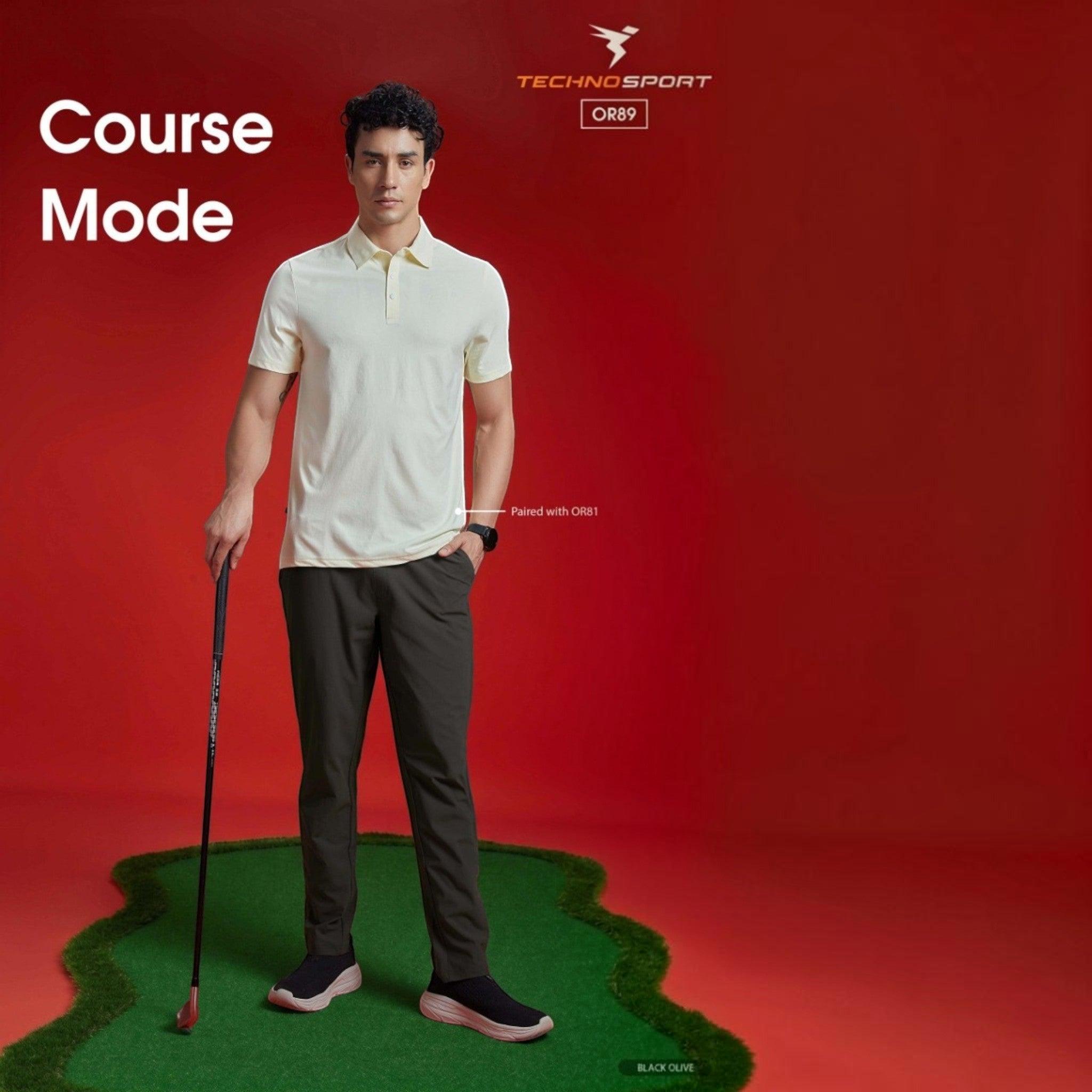City Center model wearing Technosport DuraCool+ black olive 4-way stretch track pants and a cream polo on a golf green.
