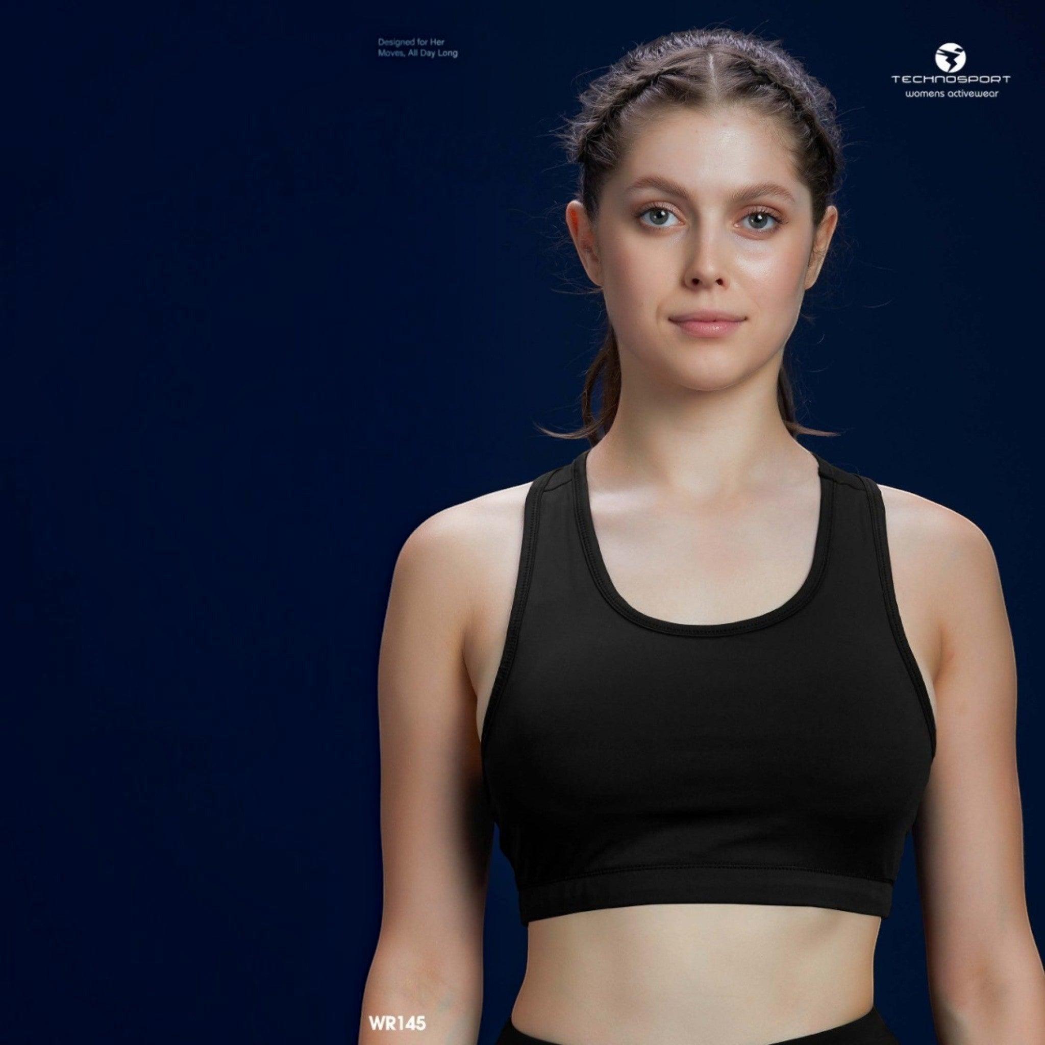 City Center Technosport Elastoplus black racer back sports bra worn by a woman against a dark blue background