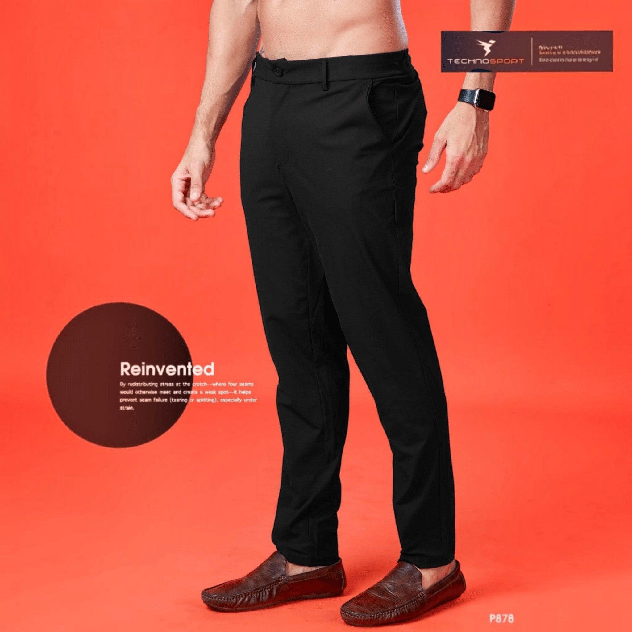 City Center Technosport Duracool+ black 4-way stretch casual trousers on a model against a bright orange background.